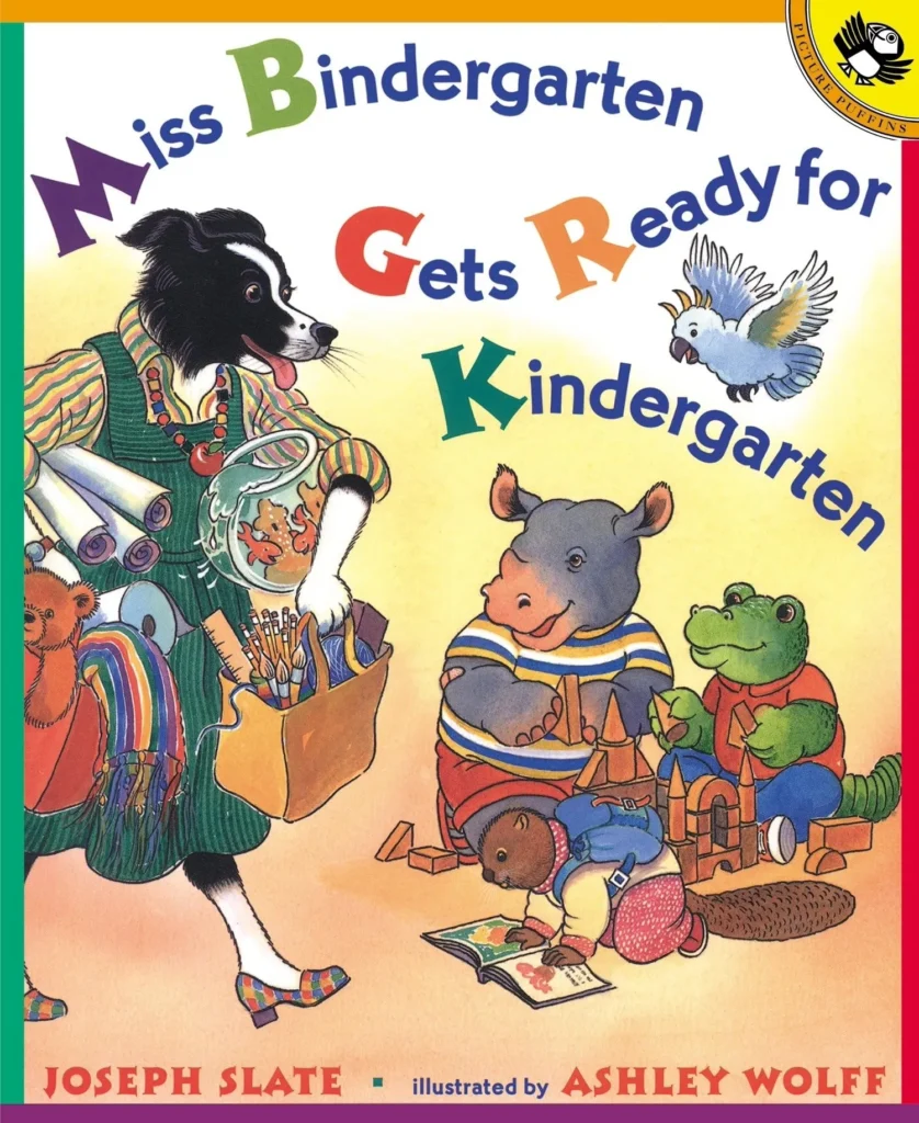 Cover of the children’s book Miss Bindergarten Gets Ready for Kindergarten by Joseph Slate, a colorful back‑to‑school story about a teacher preparing her classroom and students for the first day of school. Includes a free printable class book activity to go with the read‑aloud.