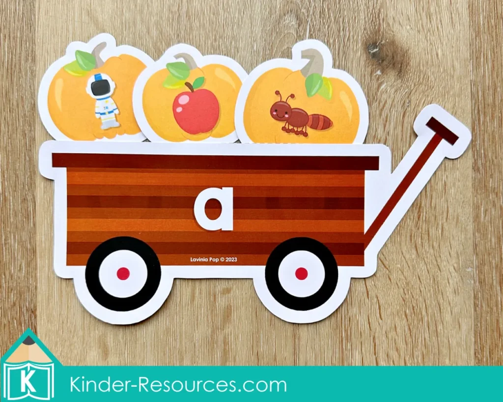Pumpkin wagon sorting activity for preschool where children match pictures like astronaut, apple, and ant to the letter A.