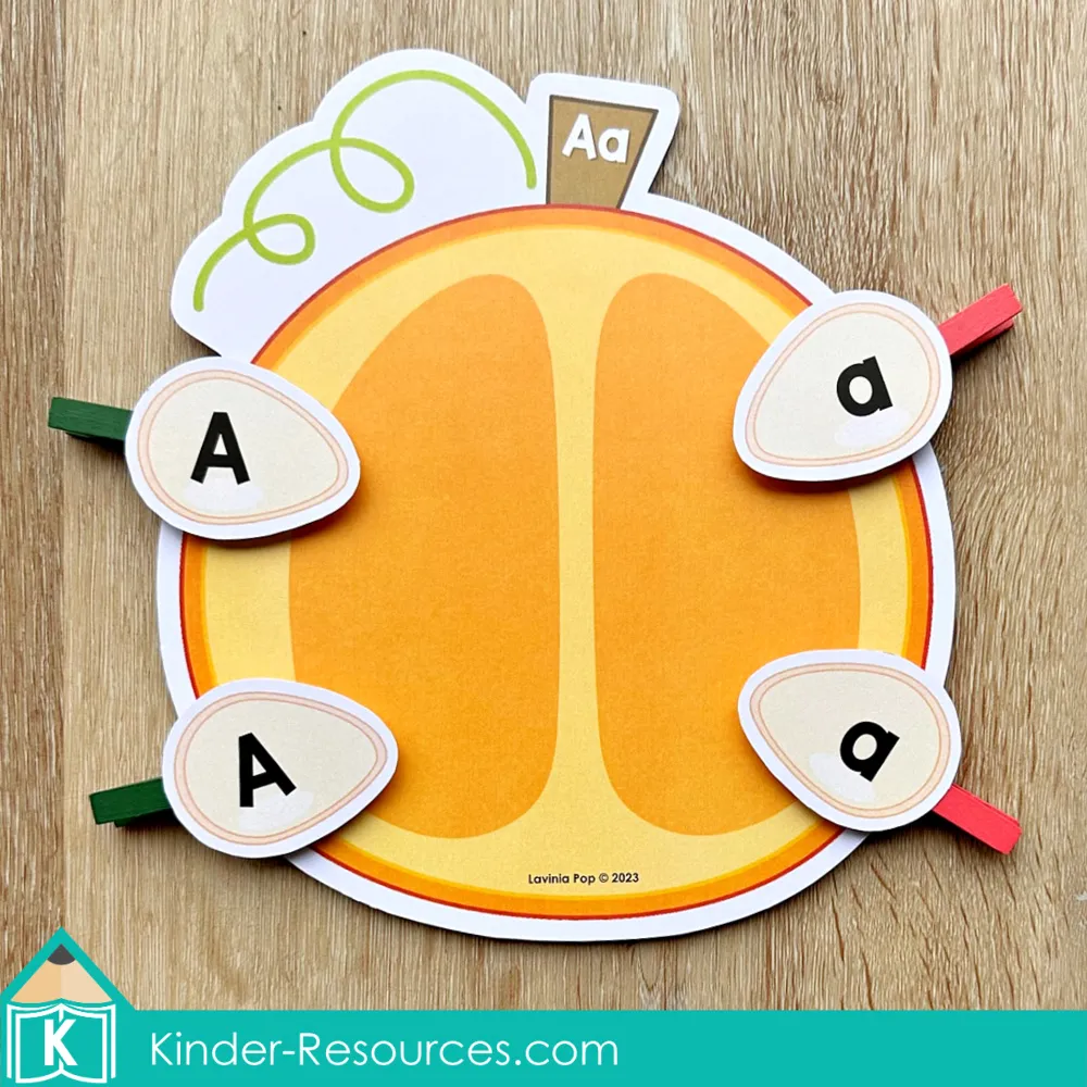 Pumpkin alphabet seed match activity for preschool where children clip uppercase and lowercase letters onto a pumpkin mat.
