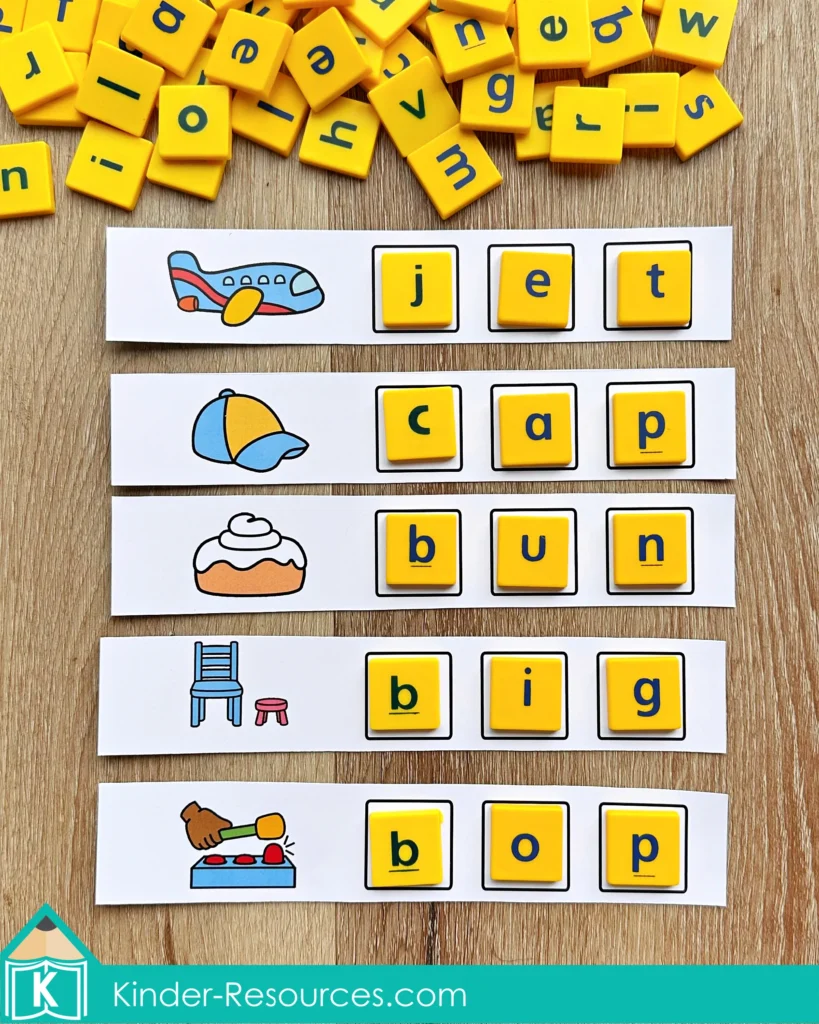 Word family word building strips with pictures and letter boxes for CVC words, used with Scrabble letter tiles for hands on phonics and early reading fluency practice.