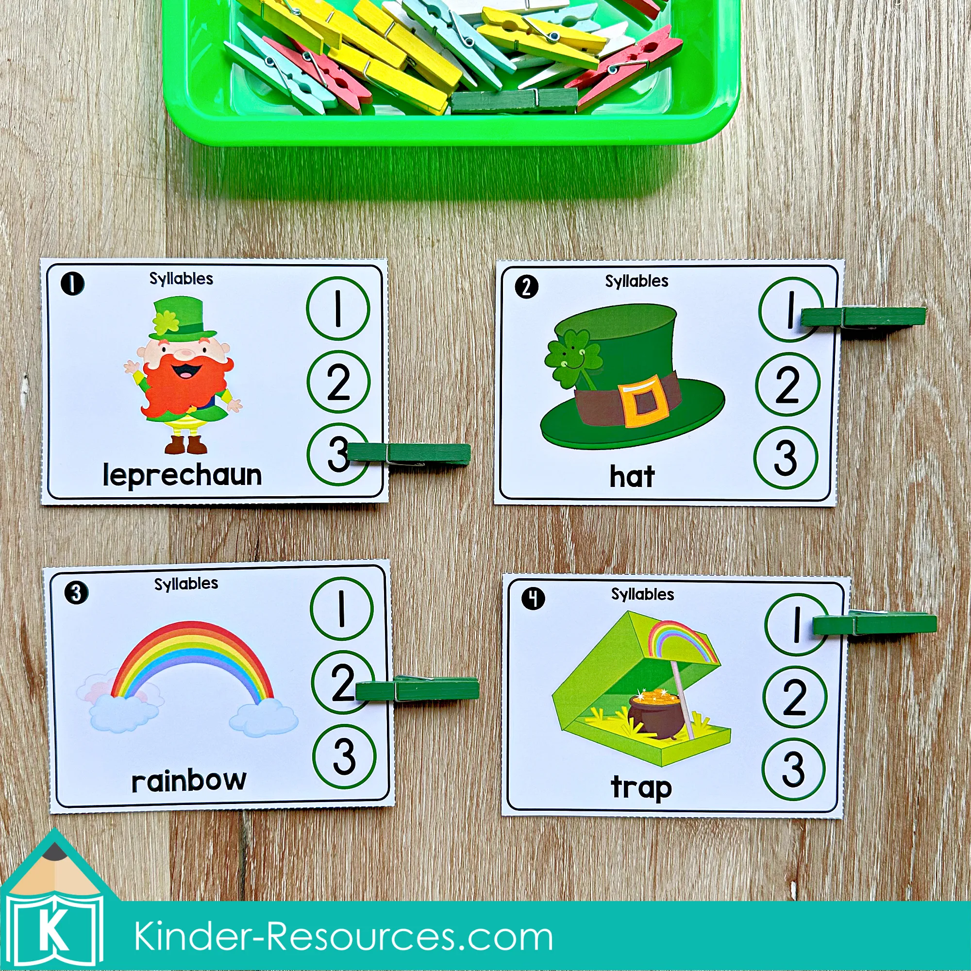 St. Patrick’s Day Syllables Clip Cards Kindergarten Literacy Center St. Patrick’s Day Literacy Centers for Kindergarten March Morning Tubs syllable clip cards with leprechaun, hat, rainbow, and trap using clothespins for phonemic awareness.