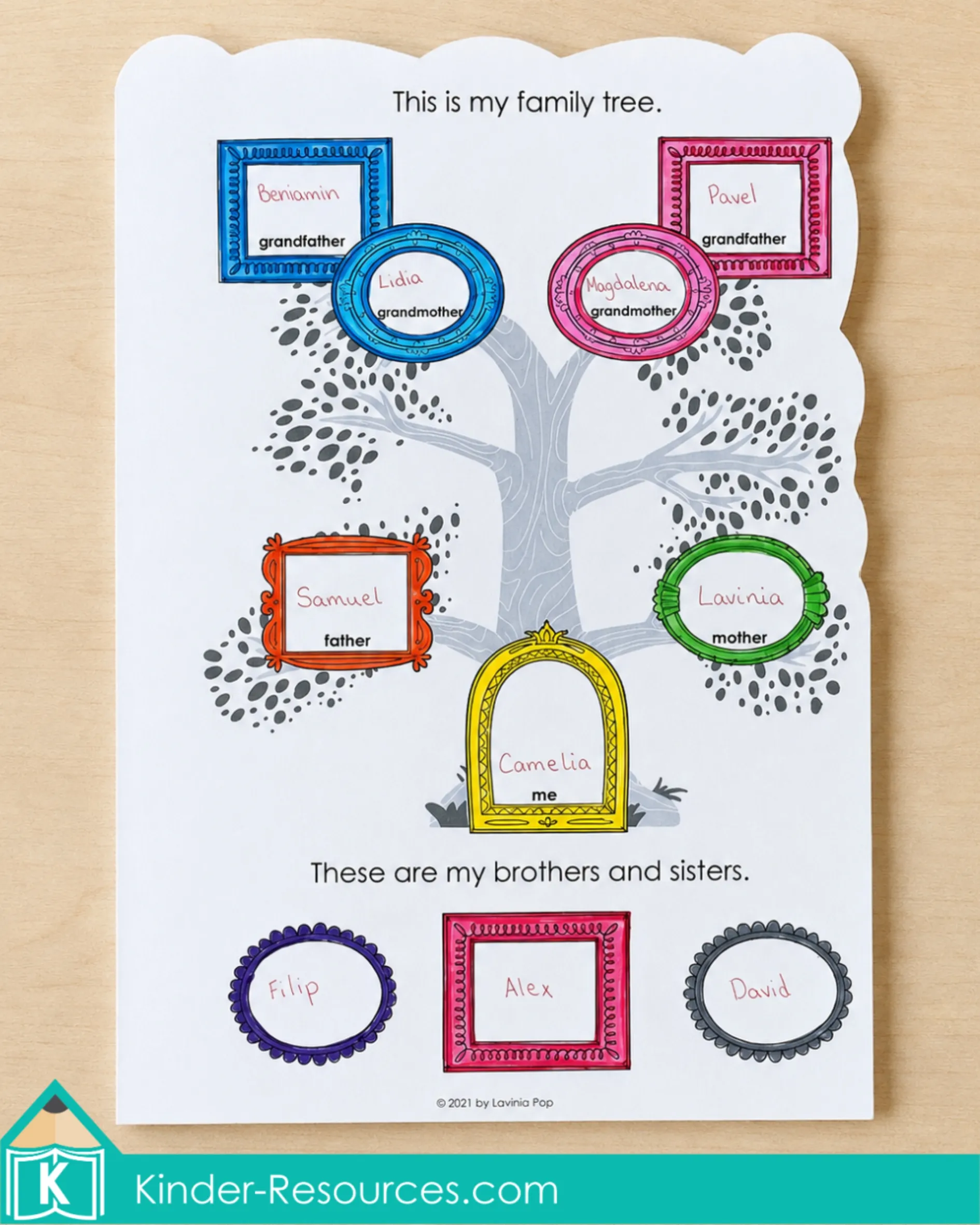 Completing a family tree page in a My Family Book by recording grandparents, parents, and siblings in colorful frames.