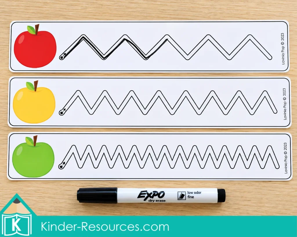 Apple centers for preschool with three zigzag tracing cards, red, yellow, and green apple pictures, and a dry erase marker.