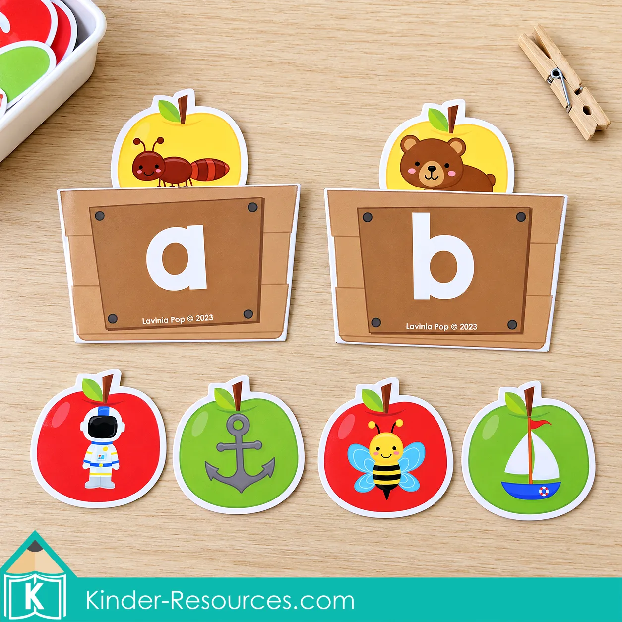 Apple centers for preschool with a and b paper crates and ant, bear, astronaut, anchor, bee, and boat picture apples.
