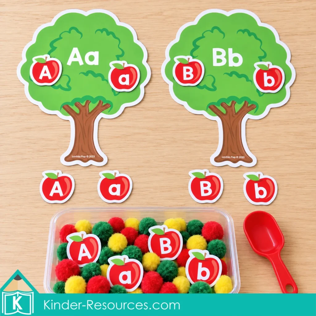 Apple centers for preschool with Aa and Bb matching trees, letter apples, a colorful pom pom sensory bin, and a red scoop.
