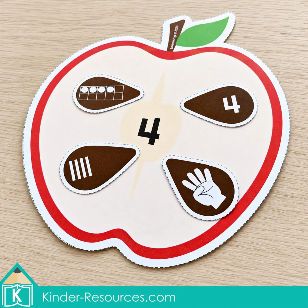 Apple centers for preschool with a number 4 apple mat and seed pieces showing a numeral, ten frame, tally marks, and finger picture.