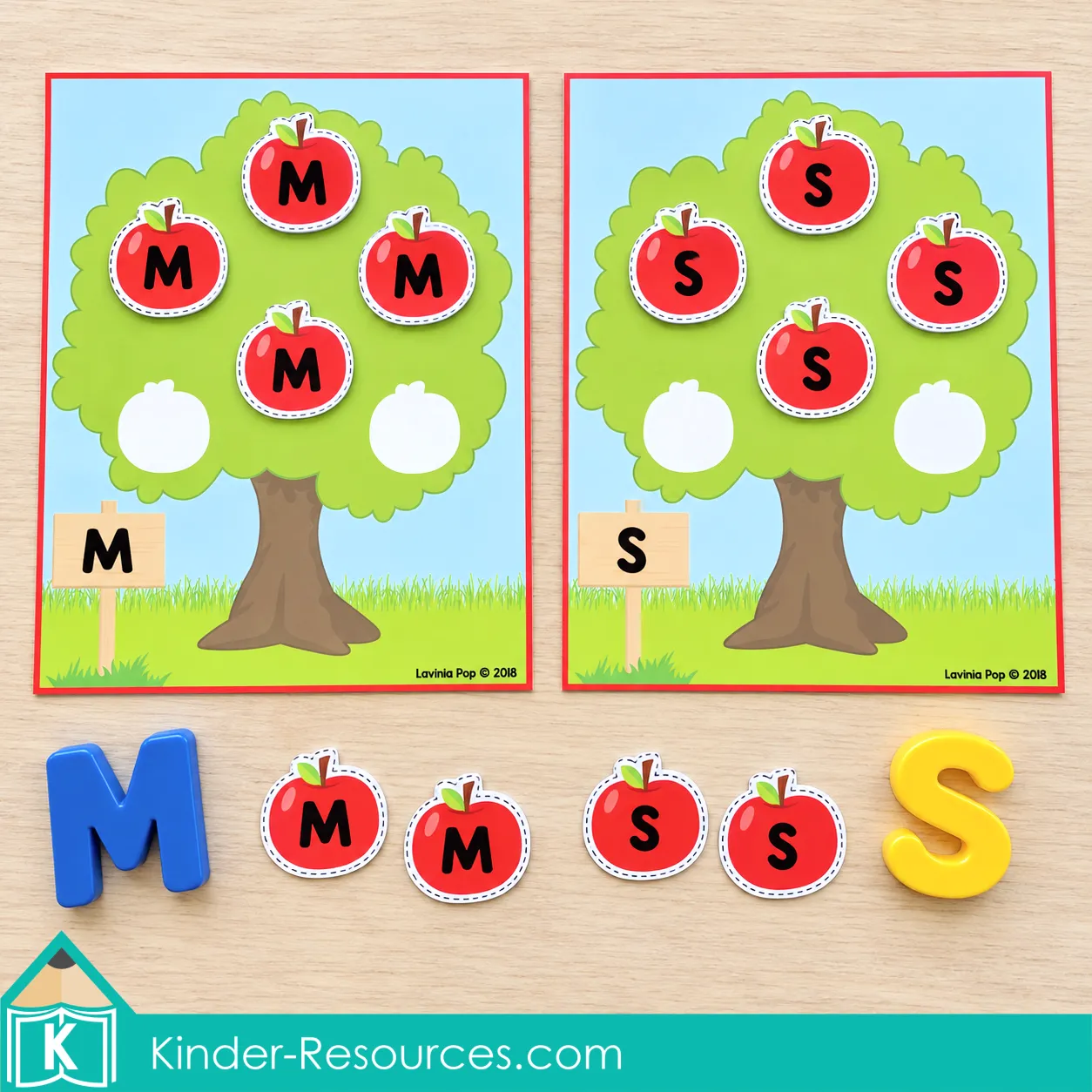 Apple tree mats labeled M and S with matching uppercase letter apples, extra apple pieces, and magnetic letters.