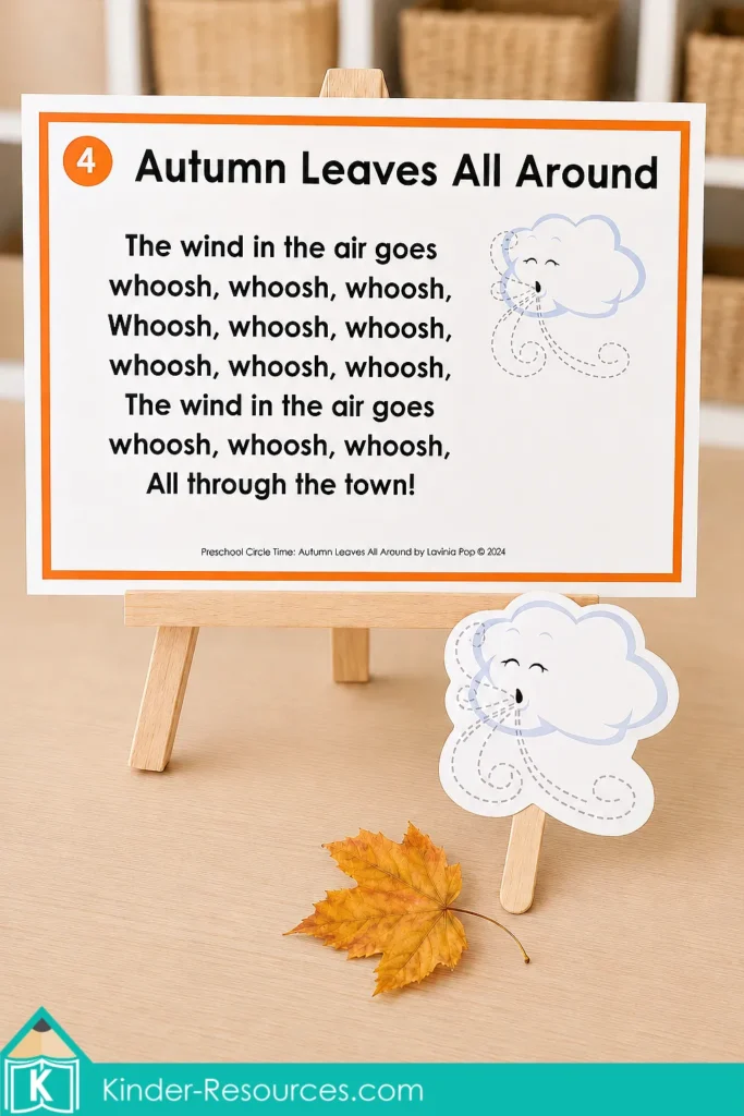 Autumn leaves preschool activities Windy Day song poster displayed on a wooden easel with a cloud prop and real autumn leaf.