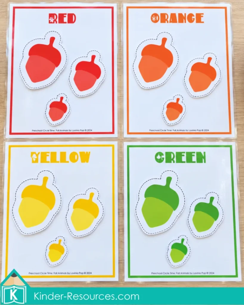 Preschool acorn color sorting activity with red, orange, yellow and green acorn cutouts placed on matching labeled mats.