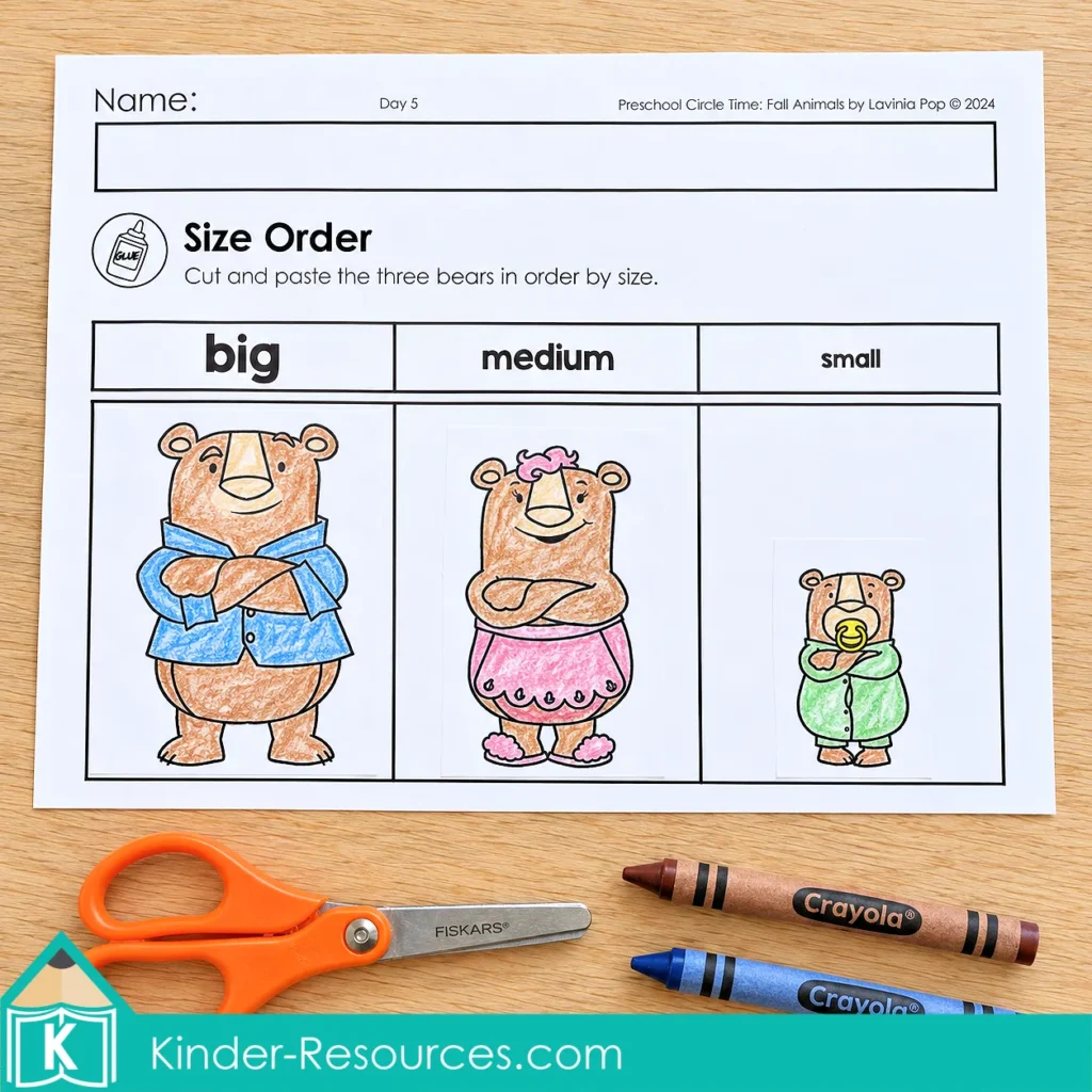 Preschool bear size ordering worksheet with three colored bears pasted beneath columns labeled big, medium and small, with scissors and crayons nearby.