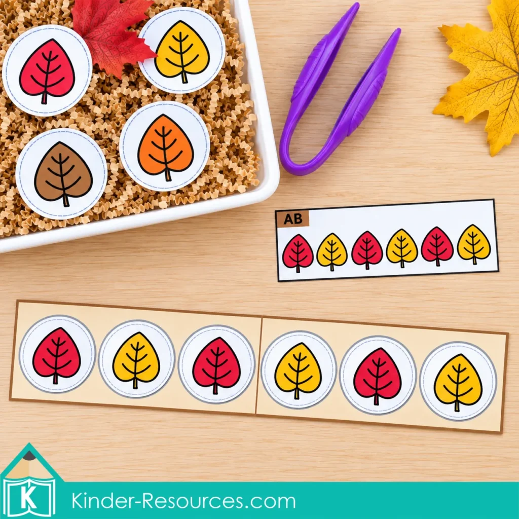 Red and yellow leaf circles alternating across two joined three-space strips, with a matching AB pattern card, sensory bin, and purple tongs.