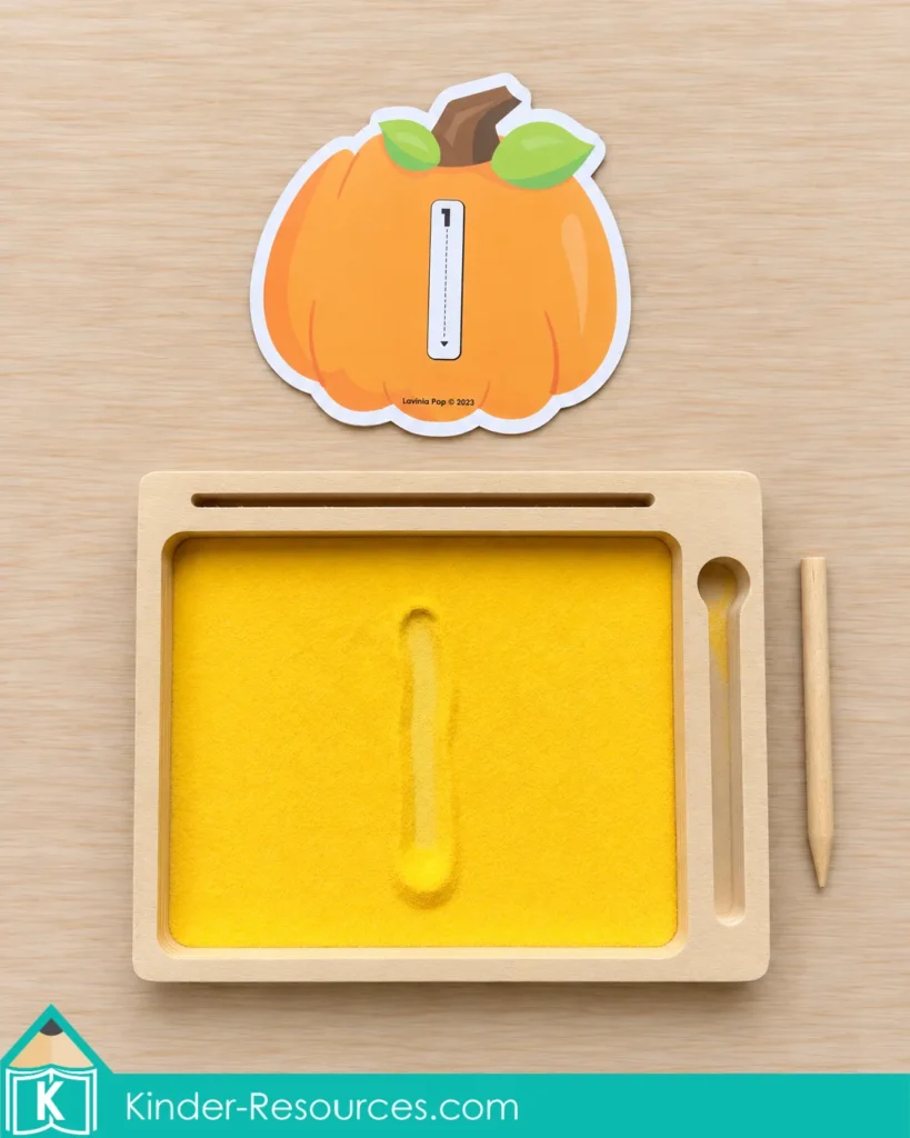 Pumpkin centers for preschool with numeral formation cards and a sand tray to practice number recognition and correct numeral formation.