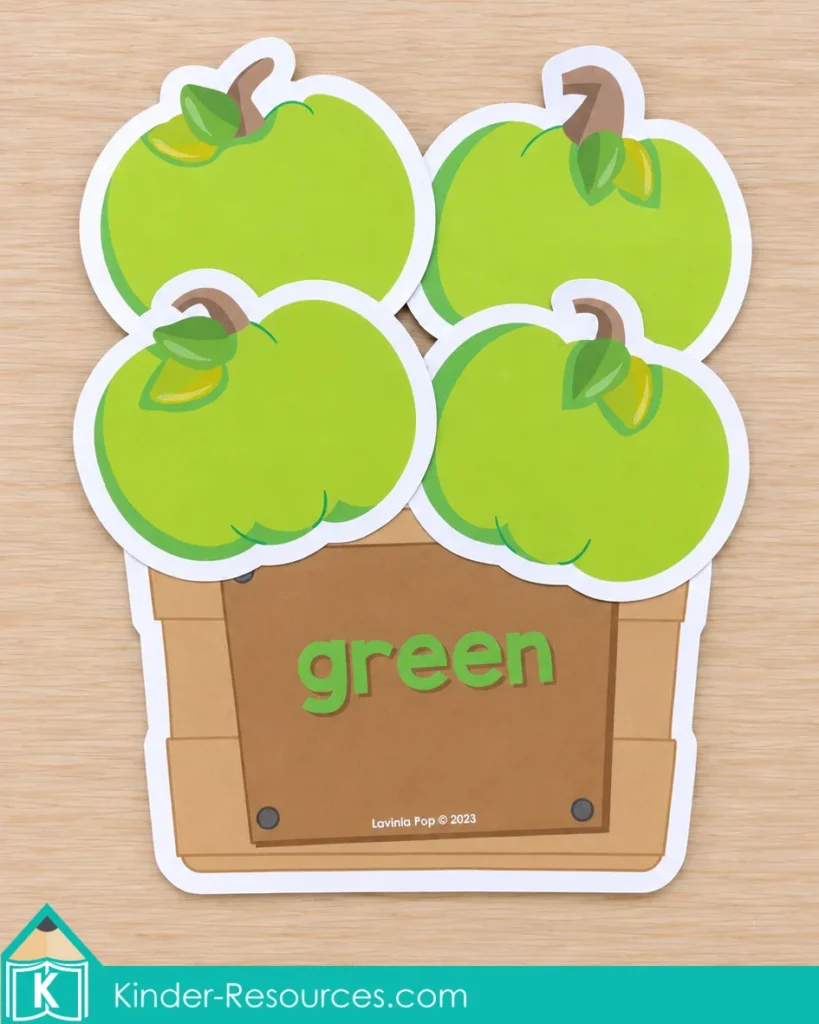 Pumpkin centers for preschool with green pumpkins and a labeled basket to practice sorting by color and recognizing the color word green.