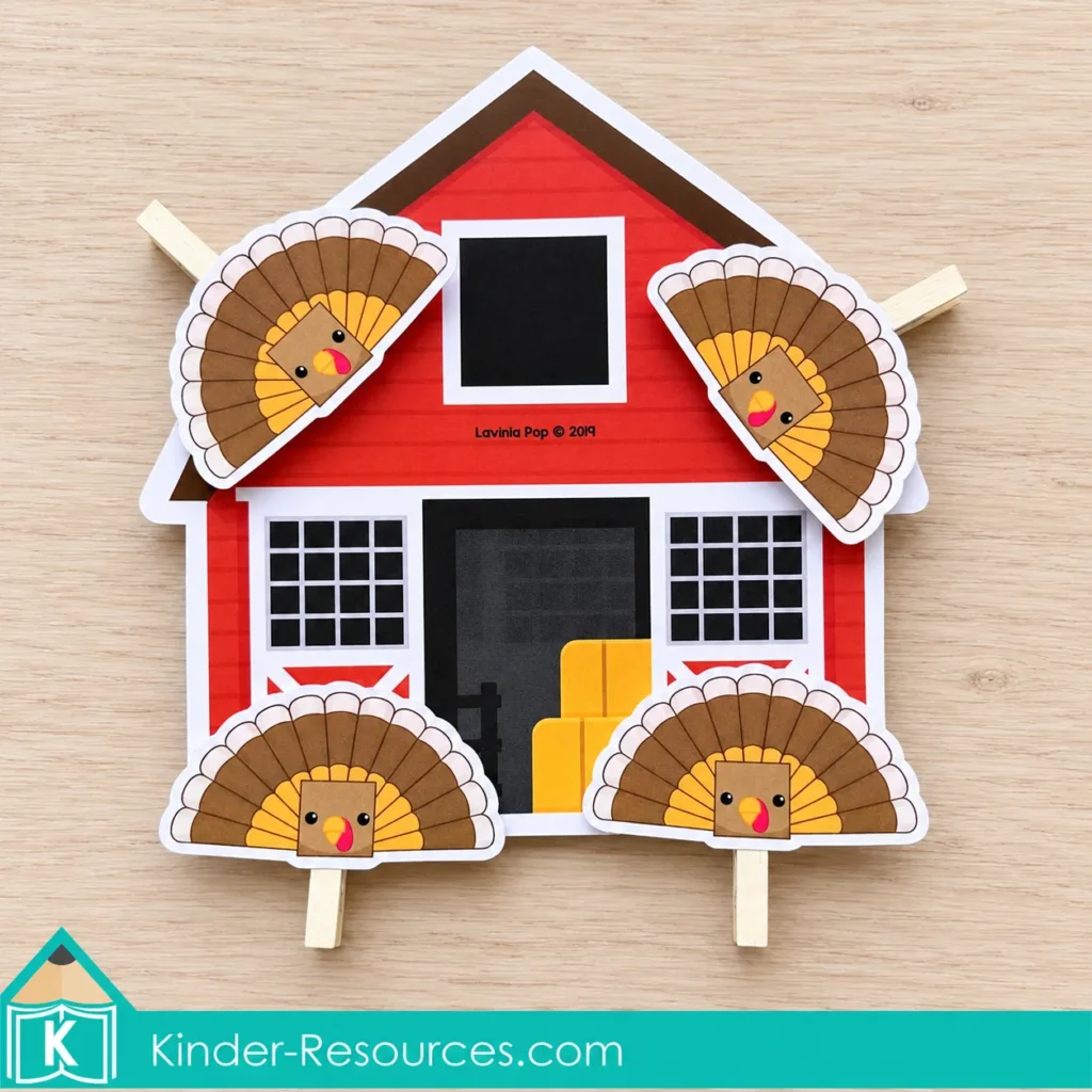 Four turkey clothespins with square faces clipped around a red barn with a matching square window.