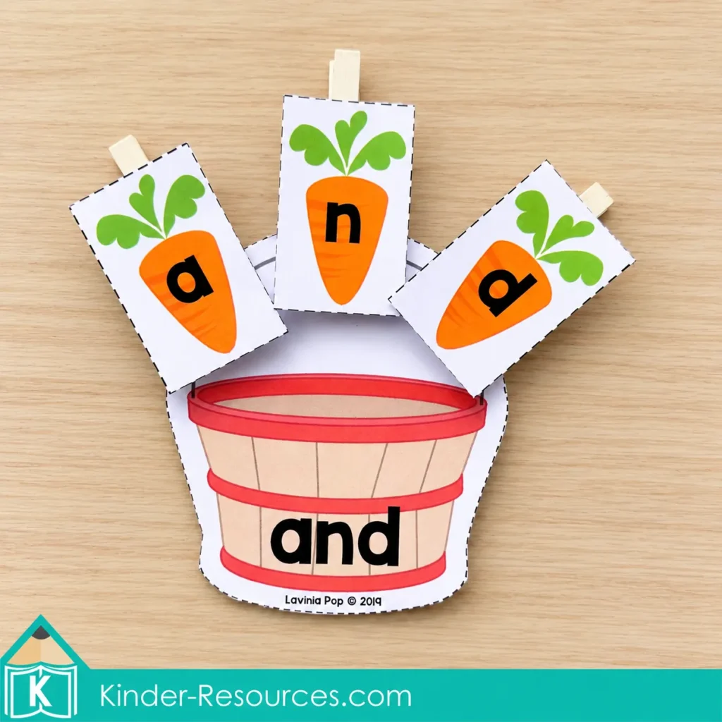 Carrot letter cards a, n, and d are attached to clothespins around a basket labeled and.
